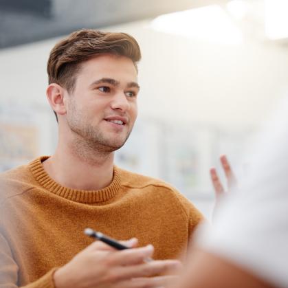 A person talks in a meeting