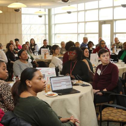 Attendees sit at tables during the Community Partner Breakfast