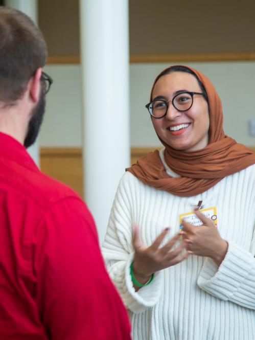 Two individuals talk at the inclusion summit