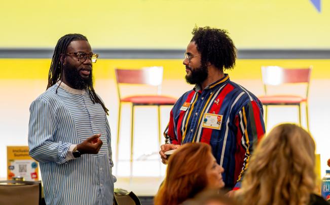 Two people standing and chatting