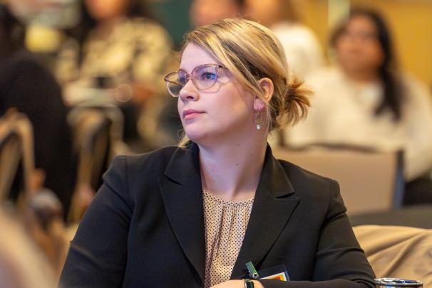 An audience member watching the presentations