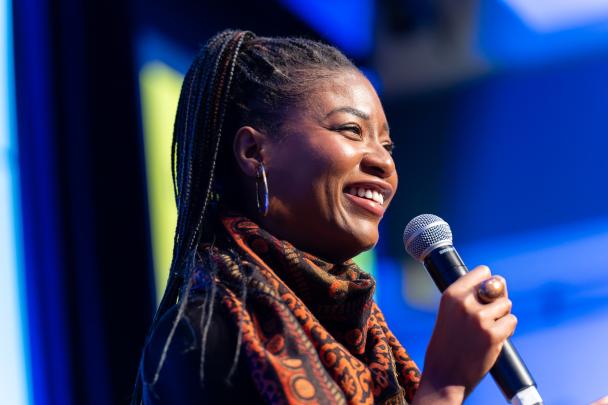 A presenter speaking into a microphone