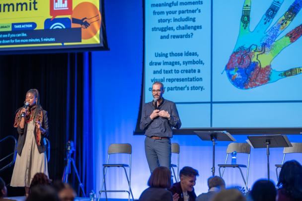 Two speakers standing on stage