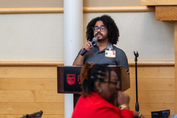 An audience member speaking into a microphone