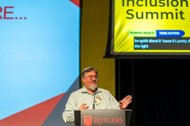 A speaker standing at a podium speaking into a microphone