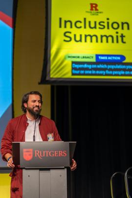 A speaker standing at a podium speaking into a microphone