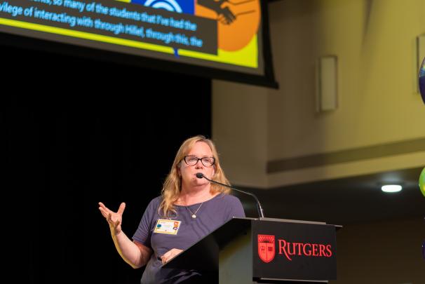 A speaker standing at a podium speaking into a microphone